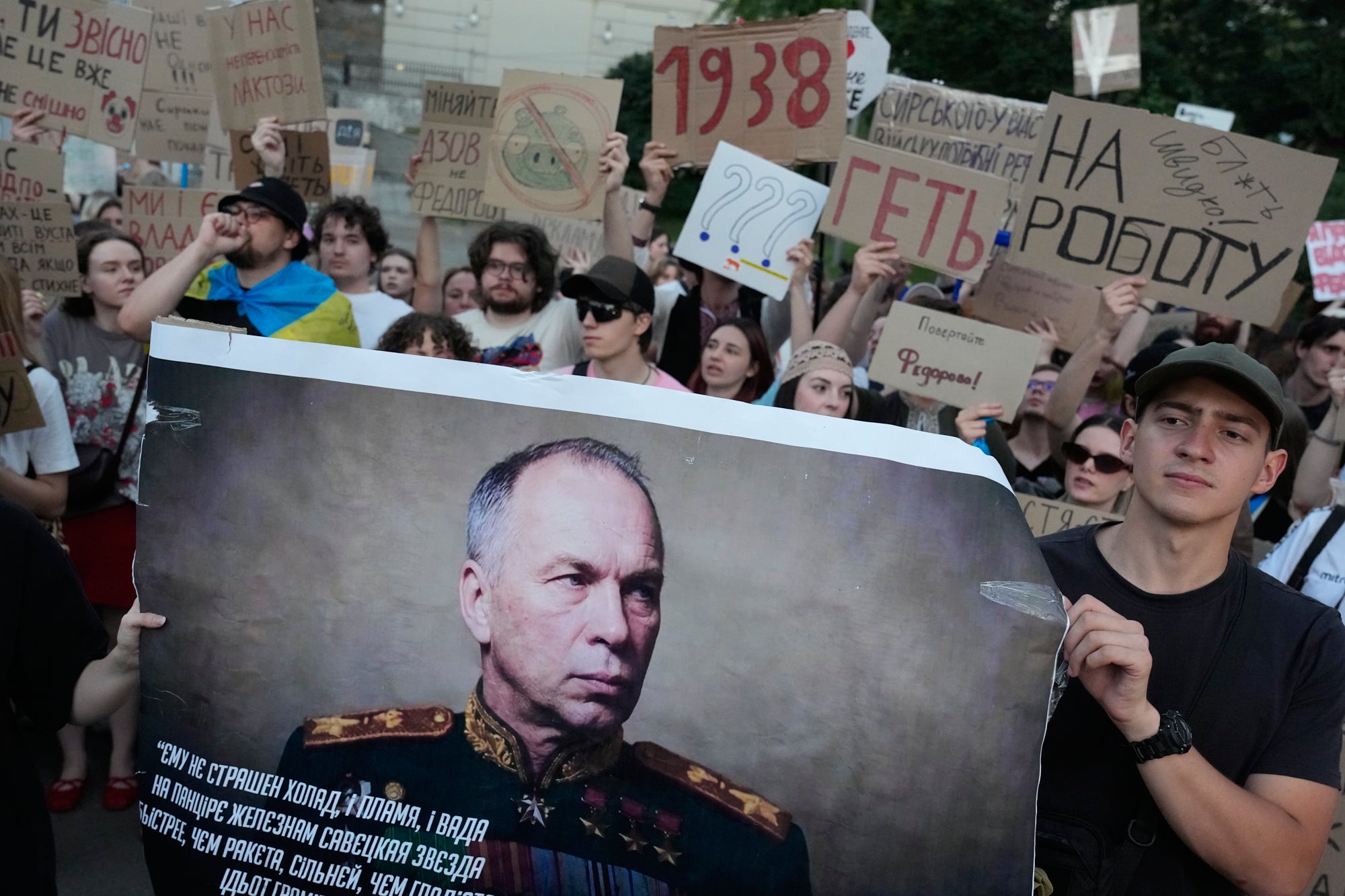Activists hold a portrait of Ukraine's Armed Forces Commander-in-Chief Oleksandr Syrskyi demanding his resignation during a rally to denounce president Volodymyr Zelensky's decision to dismiss defence minister Mykhailo Fedorov after six months in the post in Kyiv