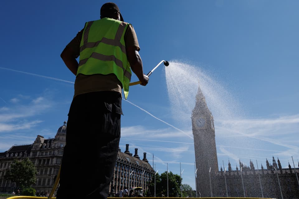 LONDON, ENGLAND - JULY 06: A worker waters the grass on Parliament Square on July 06, 2026 in London, England. The UK Health Security Agency (UKHSA) has issued yellow heat health alerts for the Midlands, East Anglia, London, and the south-east and south-west regions of England in effect through July 11, as temperatures are forecast to build into heatwave conditions. For some regions affected, the hot spell could mark the third official heatwave of the season, following record-breaking temperatures in May and June. (Photo by Dan Kitwood/Getty Images)