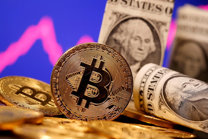 A representation of virtual currency Bitcoin and US banknotes.