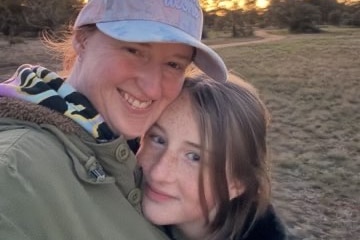 A 13-year-old girl and her mum selfie in front of a sunset.