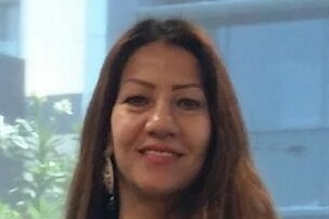 A woman smiles at the camera