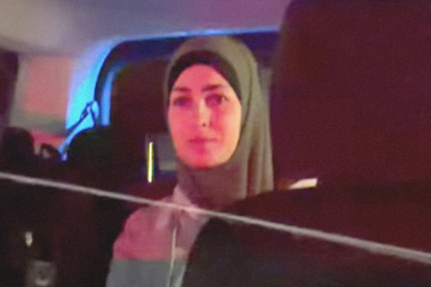 Muslim women sitting in van.