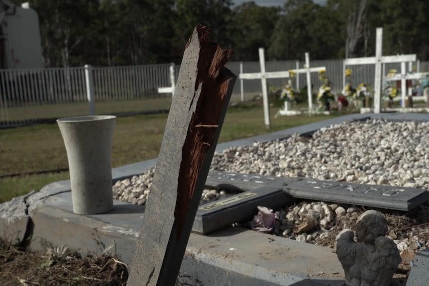 a snapped headstone at a cemetery