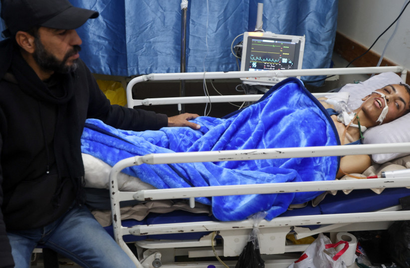 Injured Palestinian Ahmed Rasras lies on a hospital bed while waiting for the Rafah Crossing to open to seek treatment abroad, at Nasser Hospital, in Khan Younis, in the southern Gaza Strip, January 26, 2026.