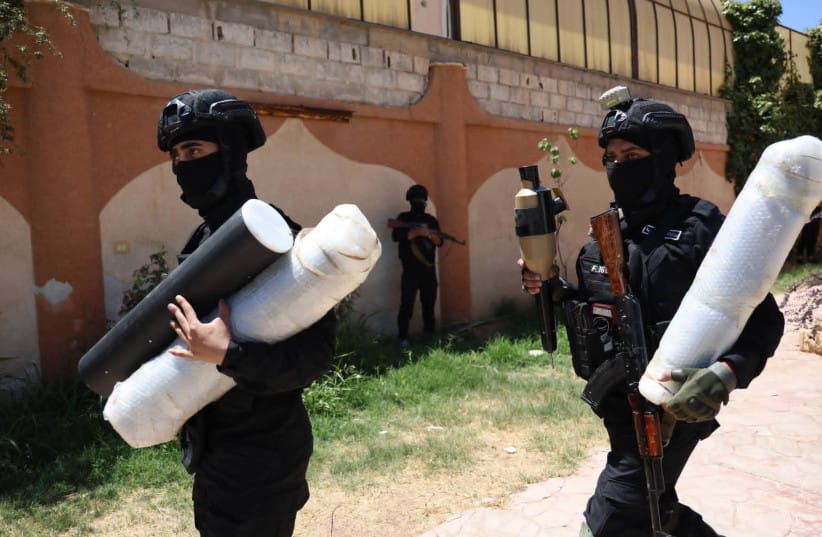 Members of Syria's Interior Ministry carry missiles and other weapons that authorities said were confiscated during an operation near the al-Tanf border crossing, July 16, 2026.