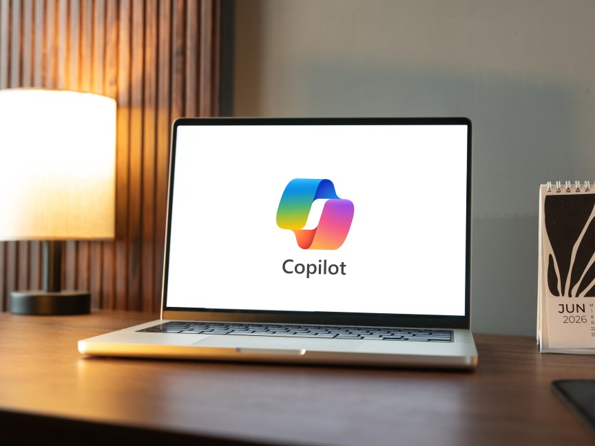 Microsoft Copilot logo on computer on wooden desk