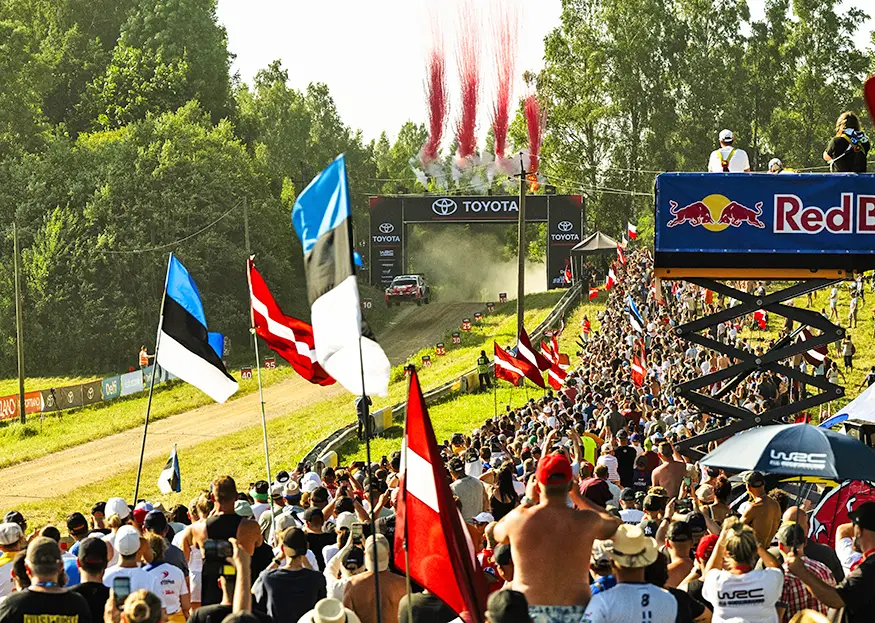 Big crowds wave Estonian and Latvian flags as Oliver Solberg's Toyota GR Yaris Rally1 leaves the Toyota start arch at Rally Estonia