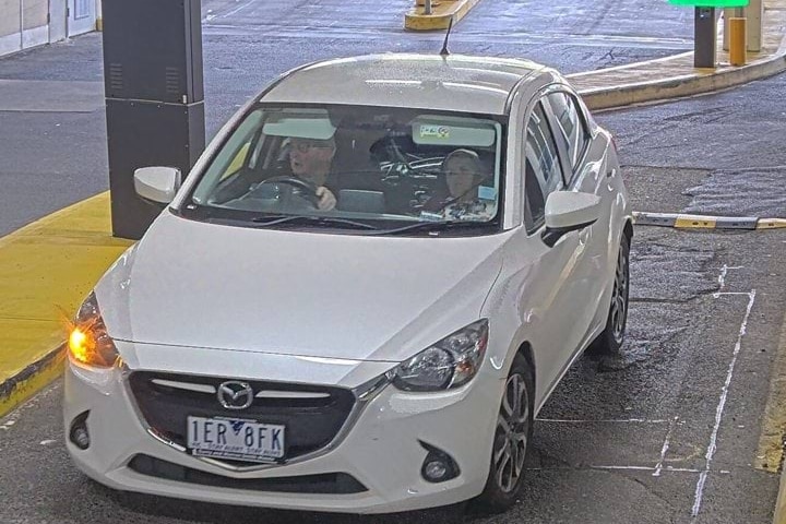 A CCTV image of a small car with two occupants