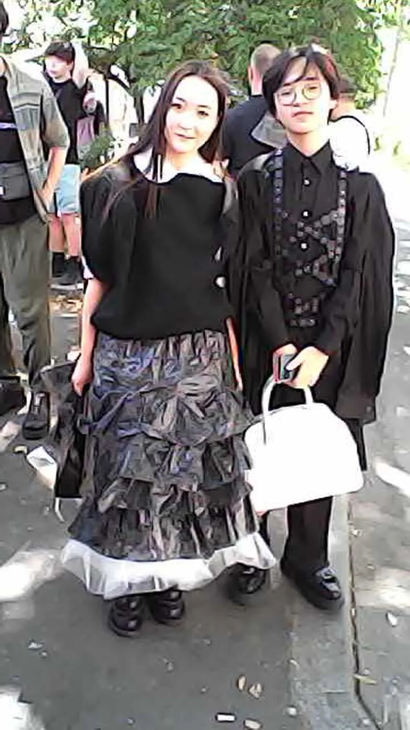 Two people dressed mostly in black