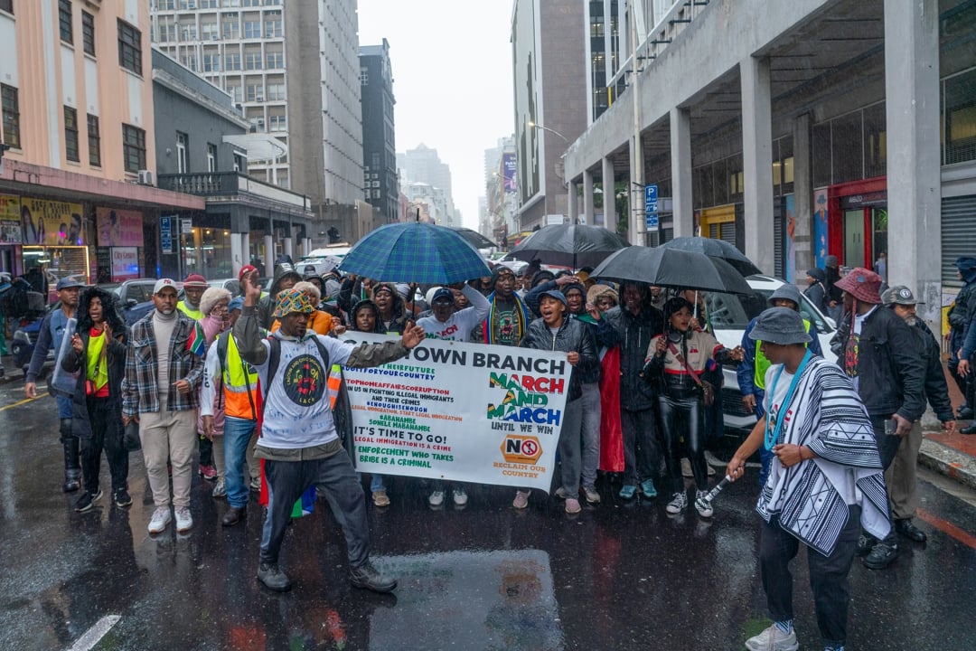 Anti-immigration protesters marched through rain-soaked Cape Town streets under heavy police guard on Thursday.