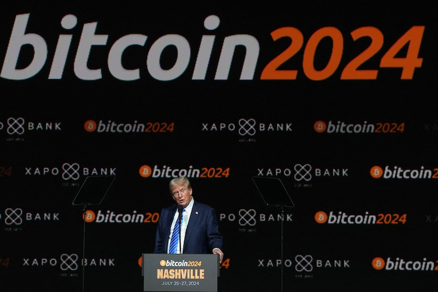 Donald Trump at podium, in front of bitcoin 2024 signage