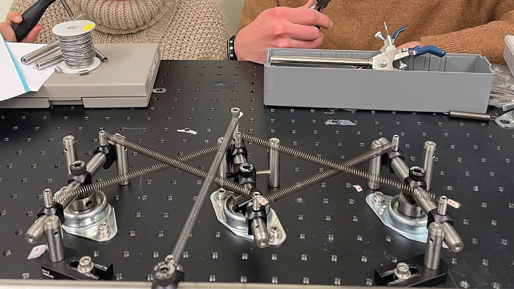 Advanced mechanical engineering experiment with interconnected metal components.