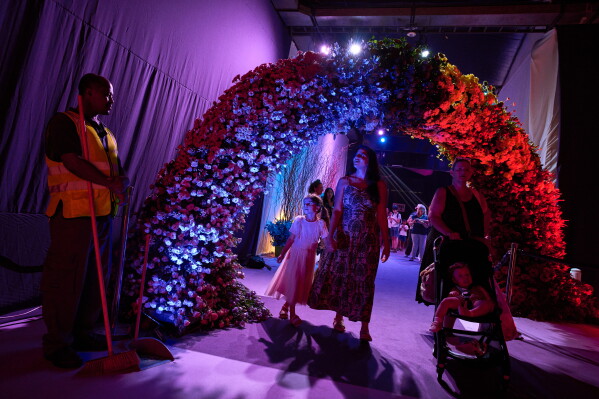 People visit the flower exhibition in Tel Aviv, Israel, Thursday, Aug. 13, 2026. (AP Photo/Oded Balilty)