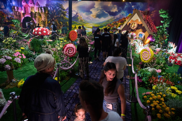 People visit the flower exhibition in Tel Aviv, Israel, Thursday, Aug. 13, 2026. (AP Photo/Oded Balilty)