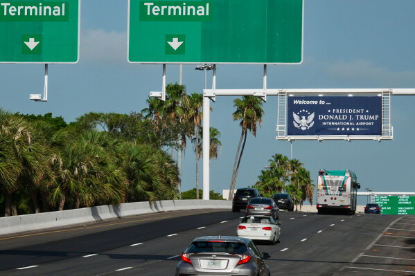 Airport visitors drive under a sign displaying the name of the rebranded Donald J. Trump International Airport in West Palm Beach, Fla., Thursday, July 9, 2026. (AP Photo/Cody Jackson)