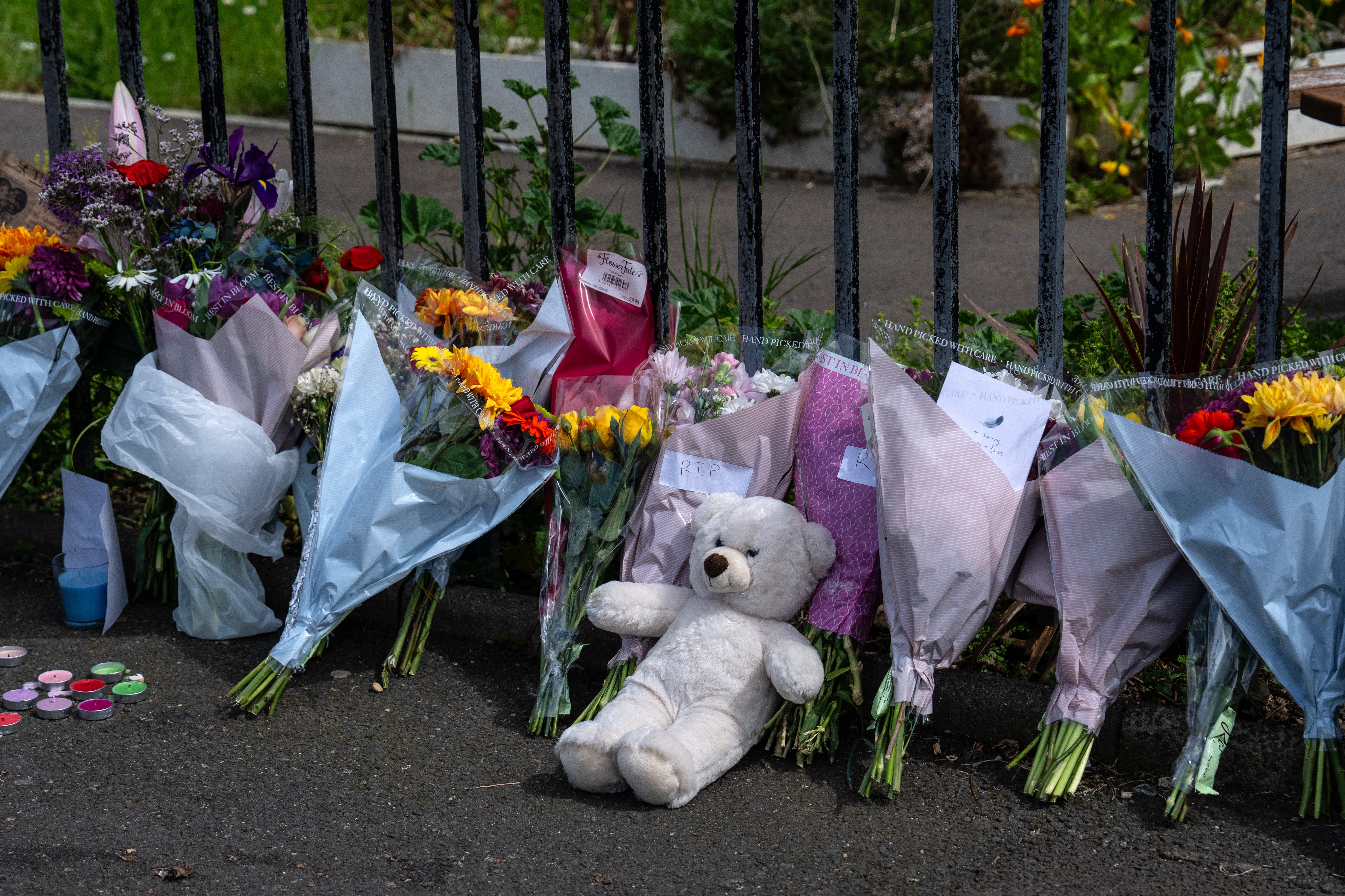 Flowers and tributes for Aalim outside the block of flats where he died