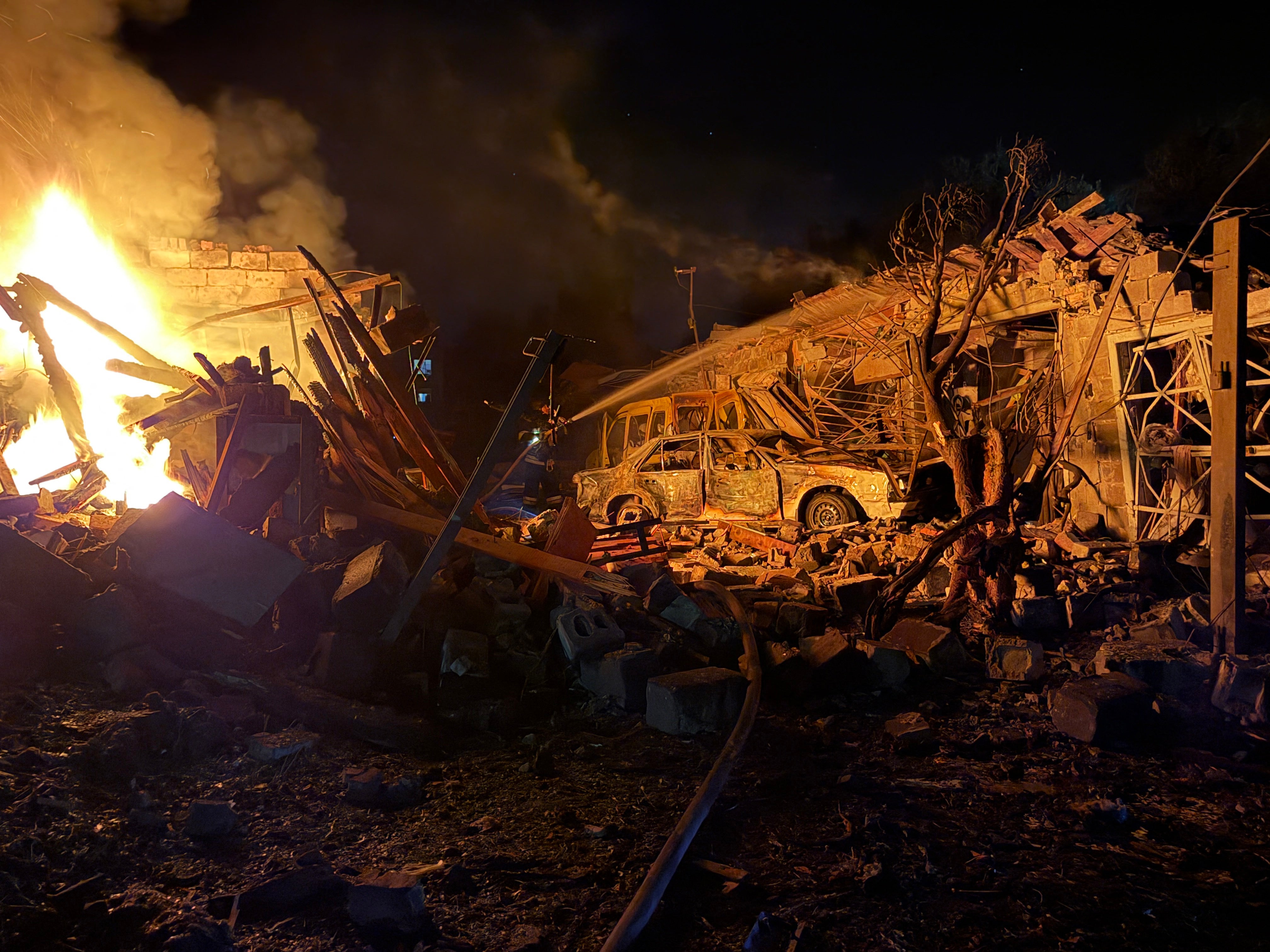 An Ukrainian rescuer works at the site of a Russian strike in Zaporizhzhia on Tuesday
