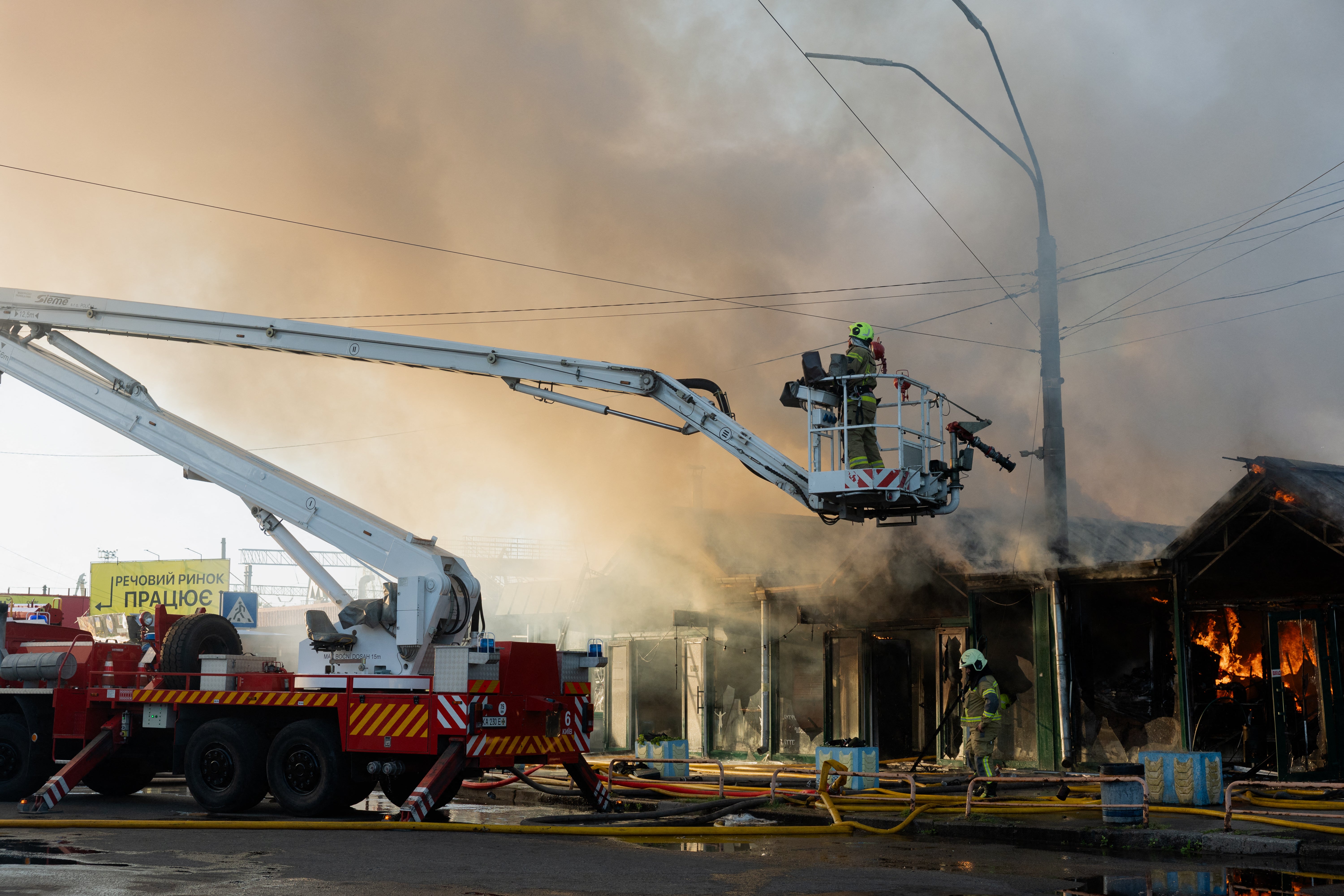 Ukrainian rescuers work at the site of a Russian strike in Kyiv