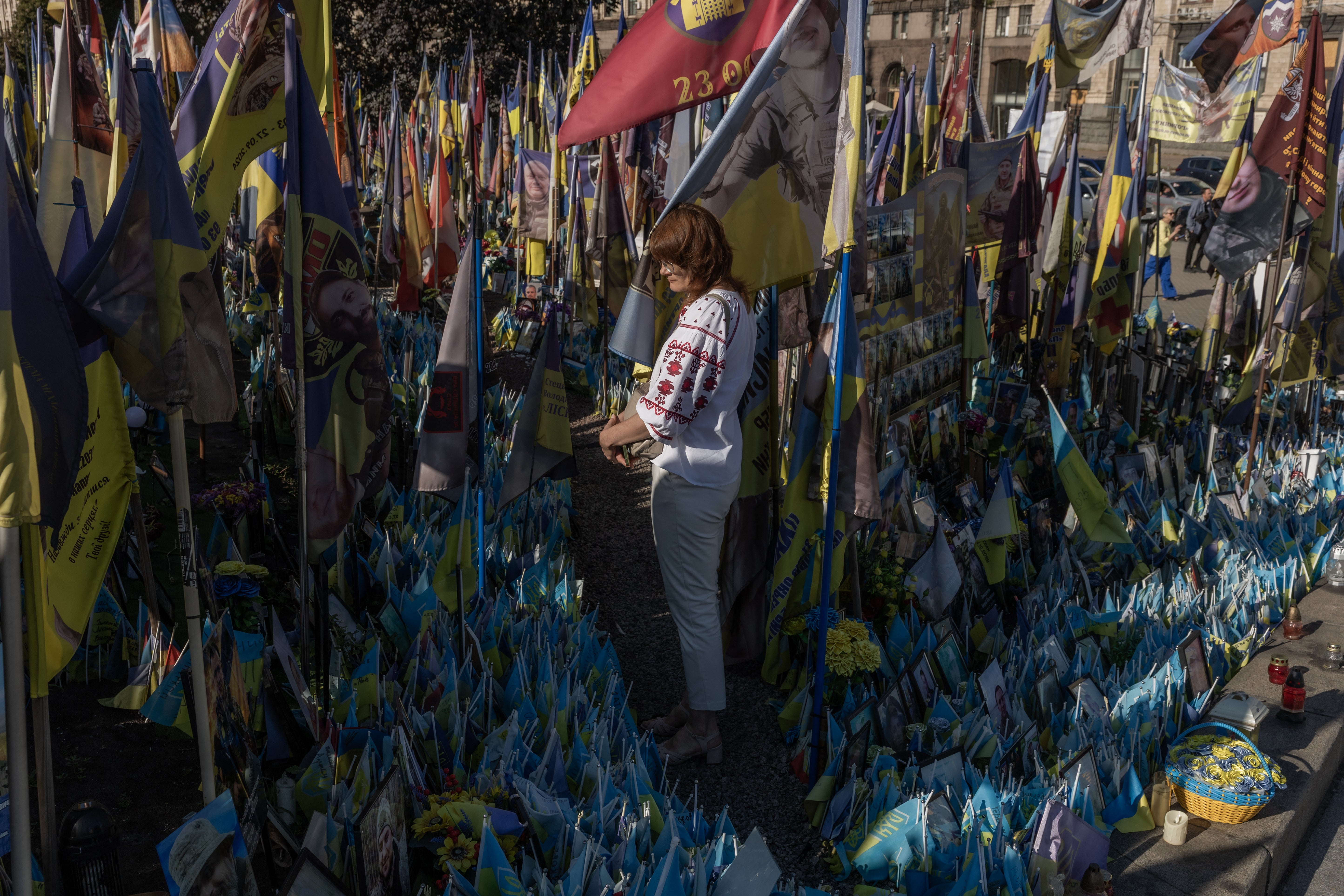 A woman visits the makeshift memorial for fallen Ukrainian and foreign soldiers during the Independence Day of Ukraine, on Independence Square in Kyiv on August 24, 2026