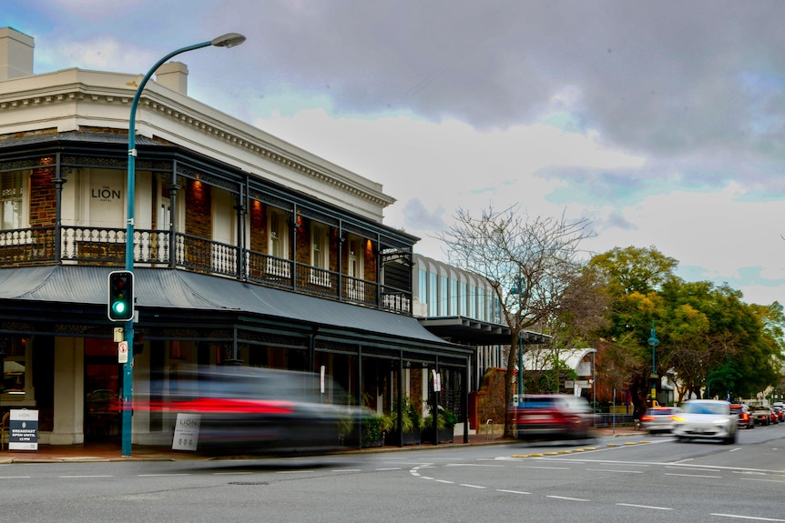 Two cars driving on a suburban street in North Adelaide