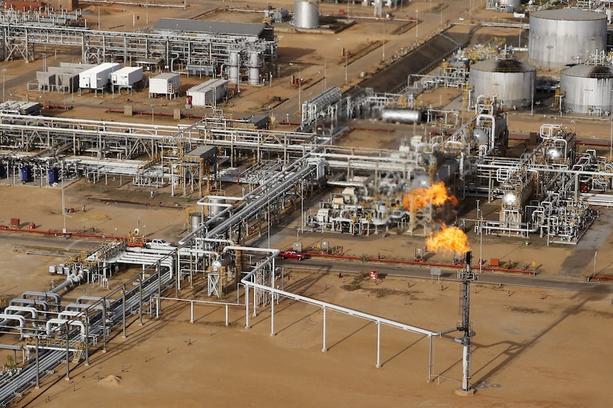 A flame burning natural gas is seen at an heavy-crude treatment plant.