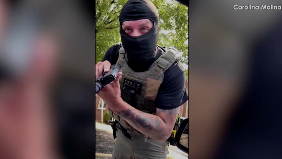 ICE agent seen on video pointing gun at woman, conflicting with government's narrative