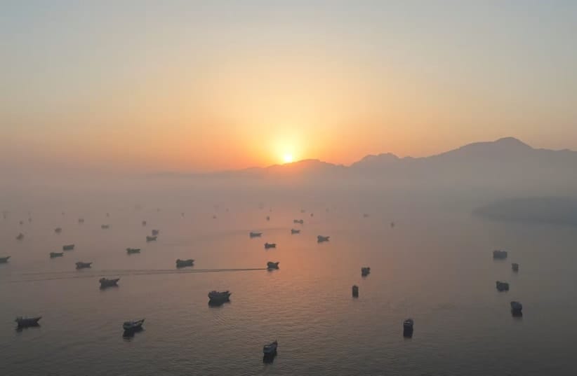 A drone view shows vessels in the Strait of Hormuz, as seen from Musandam, Oman, June 15, 2026.