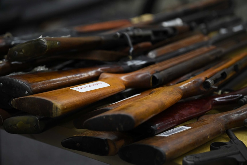 close-up of guns lying on a table.