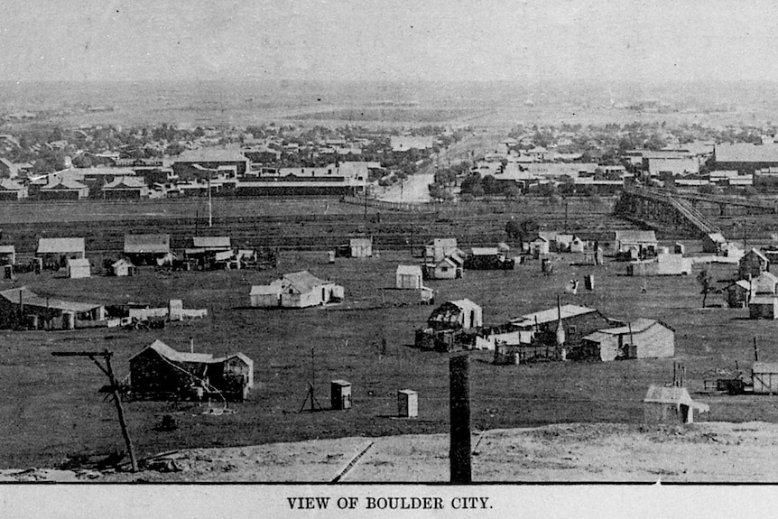 An old black-and-white photo of scattered buildings, captioned "VIEW OF BOULDER CITY".