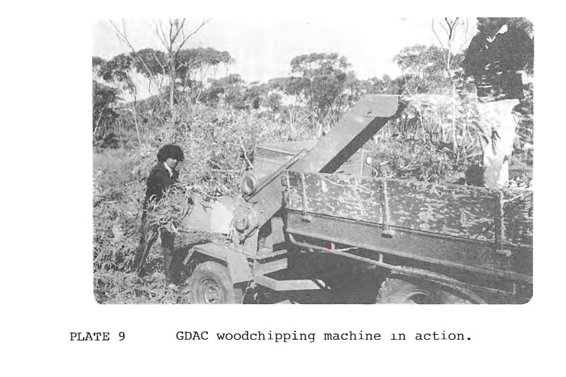 A black-and-white photo taken from a report, showing a man operating a woodchipper.