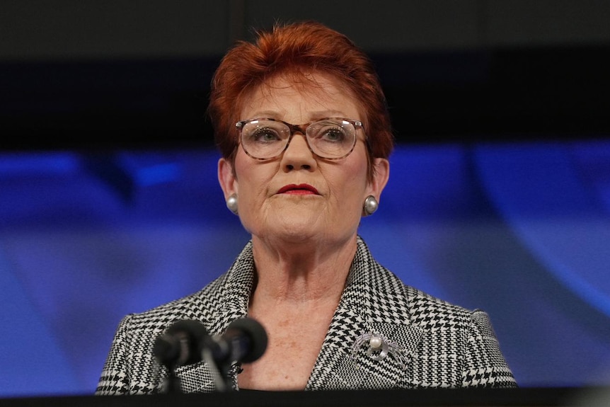 Pauline Hanson behind a lectern.