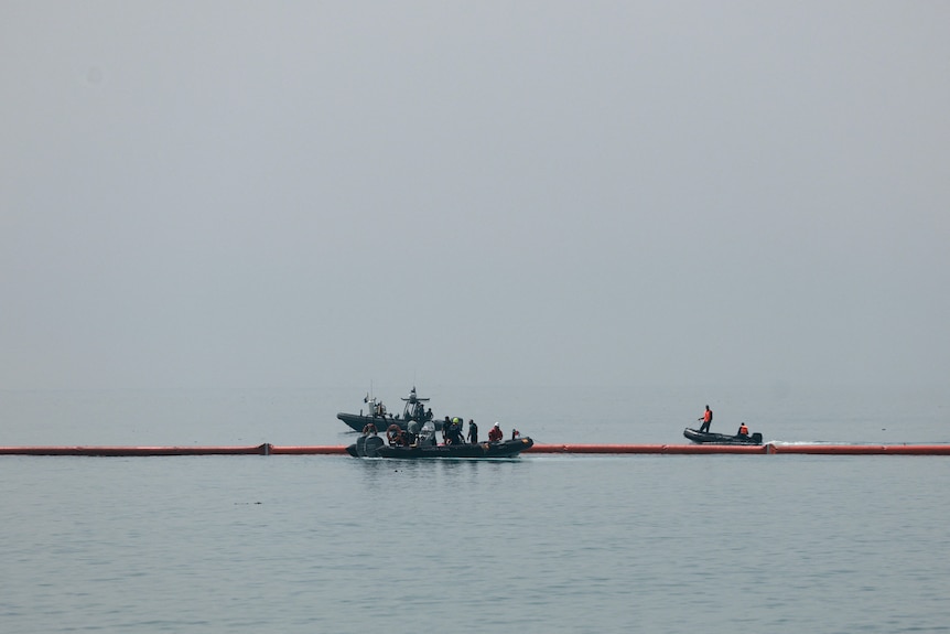 Spanish police installing a floating barrier on the water near the border with Morocco.