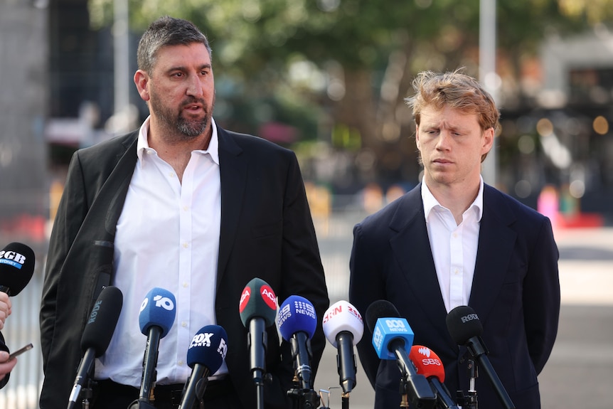 Dean Cox and Callum Mills stand at a lecturn