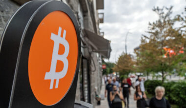 A sign with a Bitcoin logo on it is displayed outside a shop in Tbilisi, Georgia.