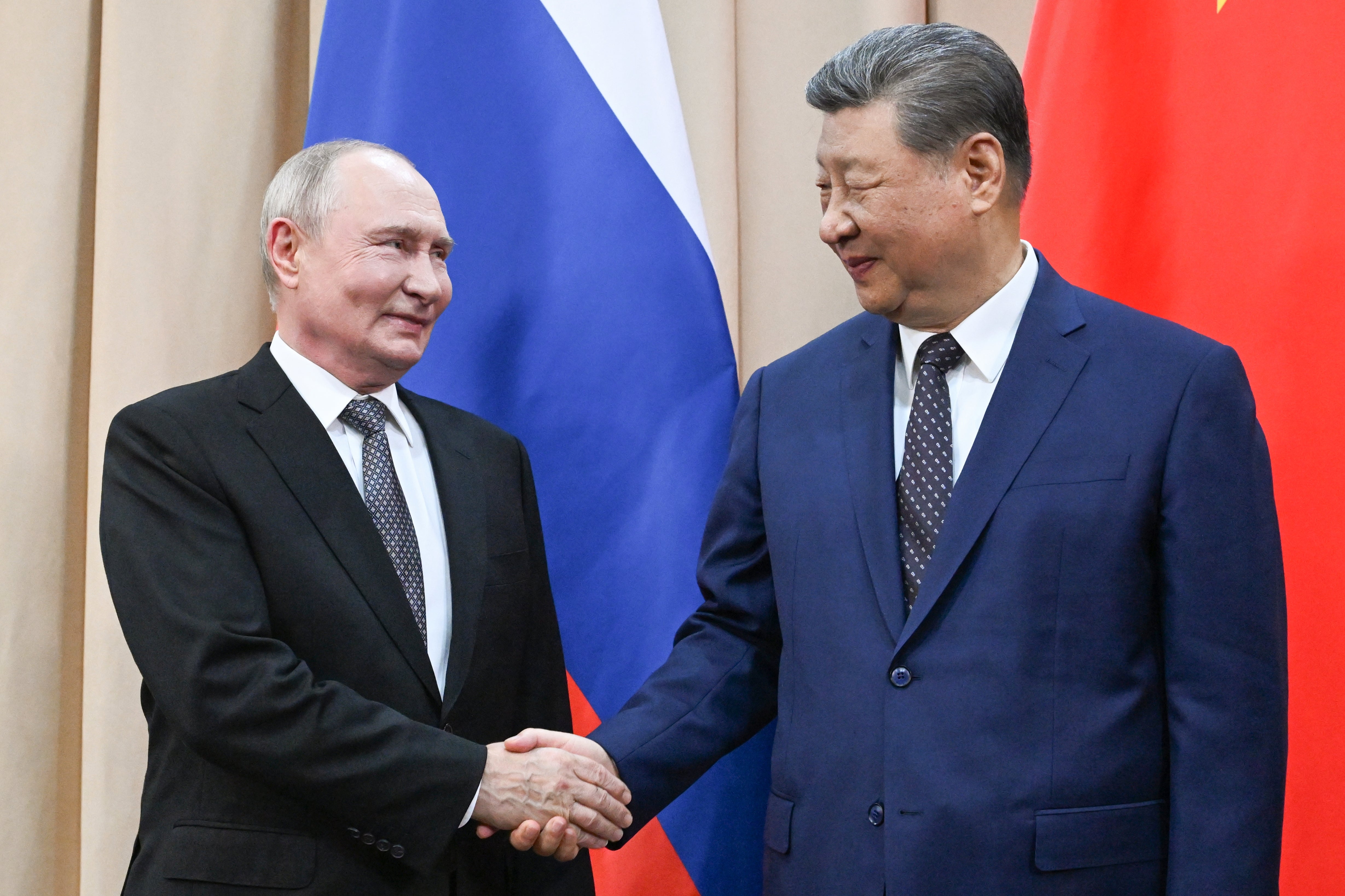 Russian President Vladimir Putin, left, and China's President Xi Jinping shake hands during their meeting on the sidelines of the Shanghai Cooperation Organization (SCO), in Bishkek, Kyrgyzstan