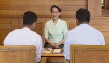 Rare photos of Myanmar’s ex-leader Aung San Suu Kyi show her receiving books sent by King Charles