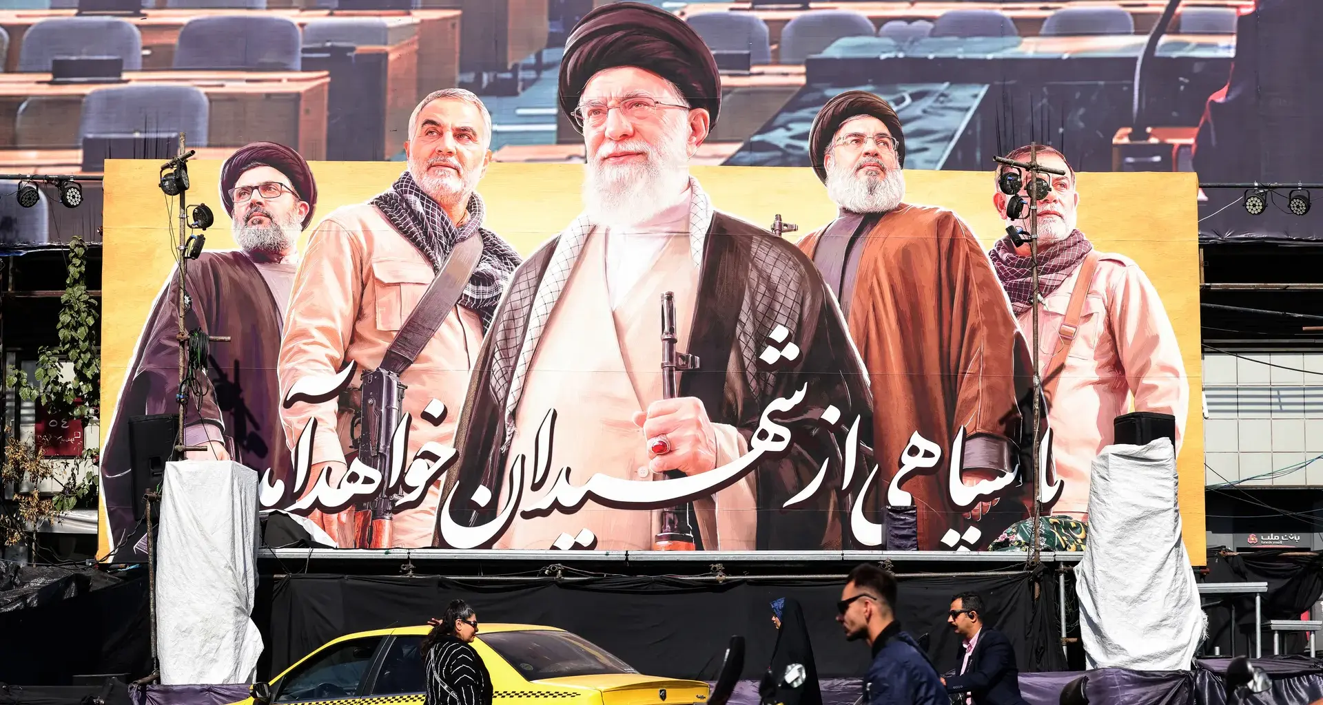 Commuters ride past a large billboard depicting slain Supreme Leader Ayatollah Ali Khamenei in Tehran this week. Photo: Atta Kenare/AFP via Getty Images